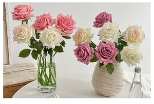 Detail of premium realistic pink and white silk roses in elegant decorative ceramic vases