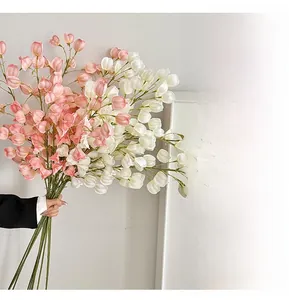Close-up of realistic artificial lantern fruit stems in soft pink and white colors