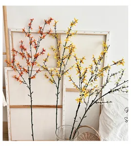 Macro detail of artificial jasmine branches in orange, yellow, and white for home decor