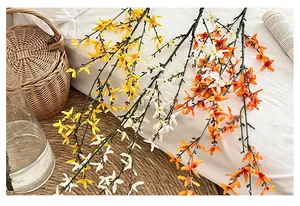 Detailed view of artificial winter jasmine branches in yellow white and orange colors