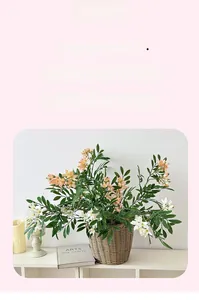 Close-up of artificial locust flowers in a woven basket for home tabletop decor