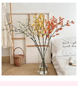 Detailed view of artificial winter jasmine branches in a glass vase for home decor