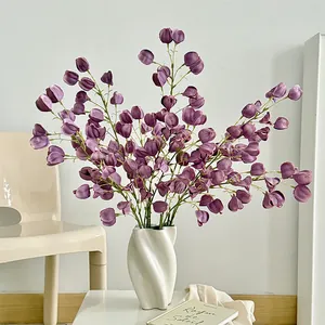 Artificial purple Physalis branches in white ceramic vase for elegant home decor