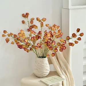 Realistic orange physalis artificial flowers in a white textured ceramic vase for home decor