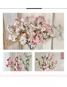 Close-up of artificial cherry blossoms with realistic white and pink petals and stamens