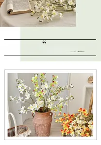 Detailed close-up of realistic white and orange Vanda orchids with green leaves in a vase