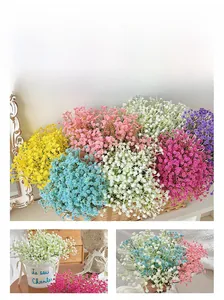 Detailed view of colorful artificial gypsophila bouquets in decorative floral buckets
