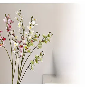 Close-up of artificial Vanda orchid branches in white, pink, and green for home decor