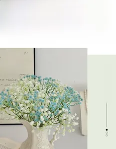Blue and white gypsophila artificial flowers in a white ceramic relief vase