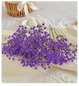 Detail of purple artificial babys breath bouquet on white knitted fabric for home decor