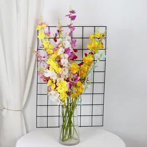 Vibrant dancing lady orchids in a clear glass vase for elegant home floral decoration