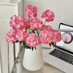 Vibrant pink faux peonies in a modern white fluted ceramic vase for elegant home decor