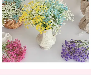 Detailed view of colorful artificial gypsophila flowers in a white ceramic vase