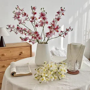 Lifelike artificial Vanda orchids in white ceramic vase for elegant home decor