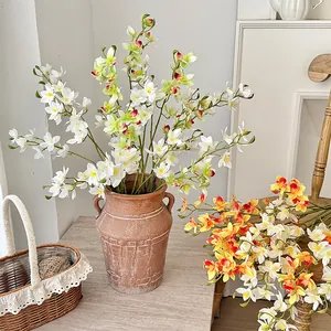 Artificial Vanda orchid spray in vintage ceramic vase for elegant home floral decoration
