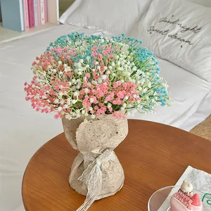 Artificial babys breath bouquet in pink blue and white wrapped in vintage kraft paper