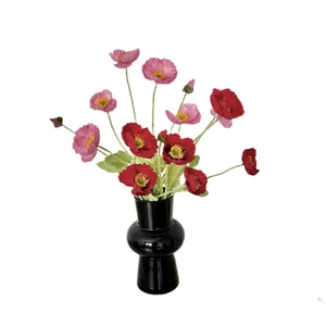 Artificial poppy silk flowers in red and purple tones with modern black ceramic vase