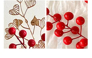 Close-up of artificial red berries and golden heart-shaped wire leaves for festive decor