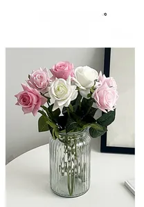 Moisturizing artificial roses in pink and white displayed in a ribbed glass vase
