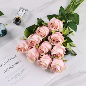 Artificial Bulgarian light pink roses bunch on marble background with magazine decor