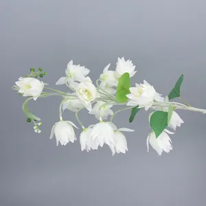 Close-up of white artificial lily of the valley flowers with flocked grey stems and buds