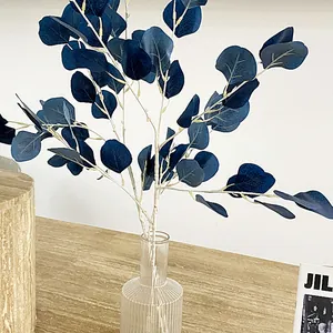 Artificial blue eucalyptus leaves in a glass vase for home and wedding decor