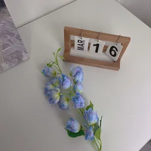 Faux blue and purple gradient lily of the valley flower branch on white table decor