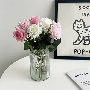 Realistic pink and white silk roses in a ribbed glass vase for elegant home floral decor
