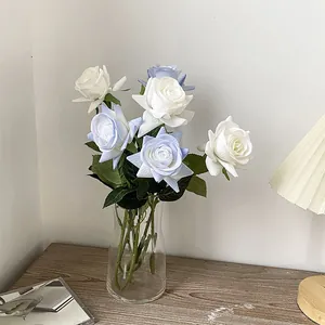 Realistic artificial white and blue roses in glass vase for modern home floral decor