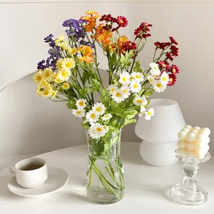 Artificial chamomile daisies in a glass vase for minimalist home decor and photography