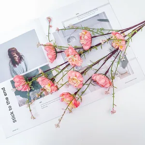 Close-up of pink artificial rhododendron flowers with green leaves on white background