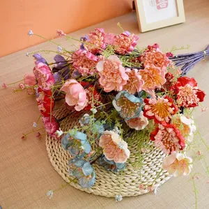Artificial azalea flower bouquet in mixed colors on a woven mat for home decoration