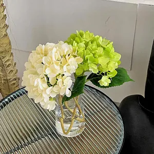 Artificial hydrangea set in glass vase with white and green blooms for home decor