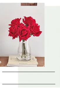 Detailed view of artificial red roses in a glass vase with realistic petal textures