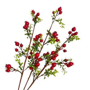 Realistic artificial pomegranate branch with red berries and green leaves on white background
