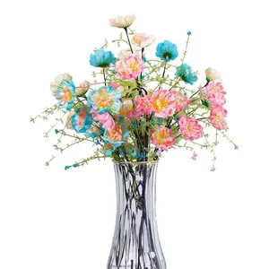 Artificial pink and blue azalea flowers in a ribbed glass vase for home decor