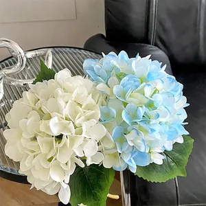 Elegant faux hydrangea flower arrangement in white and light blue for home wedding decor