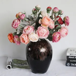 Arrangement de pivoines artificielles réalistes dans un vase sombre pour décoration