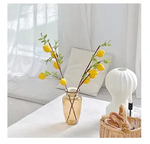 Detailed view of artificial lemon branches with realistic yellow fruit and green leaves