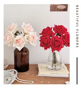 Detail of pink and red moisturizing silk roses in glass vases with decorative pearls