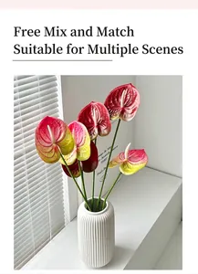 Vibrant red and green gradient 3D printed anthurium flowers in a white ceramic vase