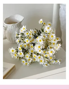 Close-up of white artificial chamomile daisies with yellow centers in a lifestyle setting