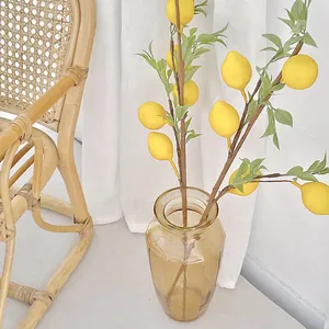 Artificial lemon branch set with amber glass vase for minimalist home interior decor