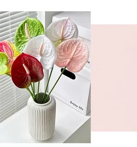 Artistic collection of multi-colored 3D printed anthurium flowers in a white ceramic vase