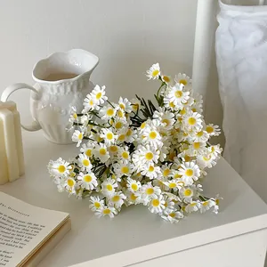 Artificial white chamomile bouquet in a vase on table for minimalist home decor