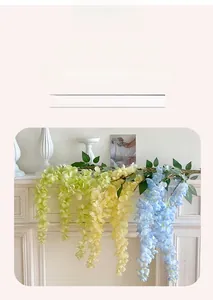 Close-up of artificial wisteria flowers in blue and yellow for wedding ceiling decor