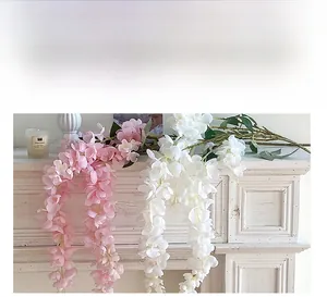 Detailed view of pink and white artificial wisteria flowers with realistic silk petals