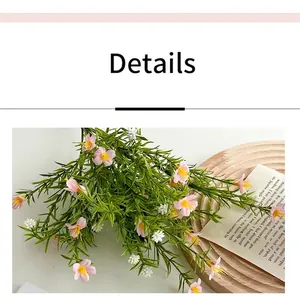 Macro detail of artificial baby breath flowers with pink petals and green leaves