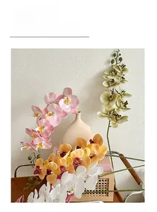 Detailed close-up of colorful artificial orchid petals in a stylish ceramic vase