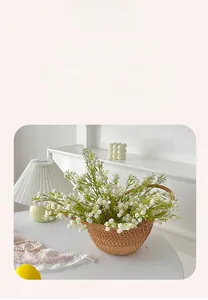 Detail of white artificial baby breath flowers in a brown wicker basket home decor